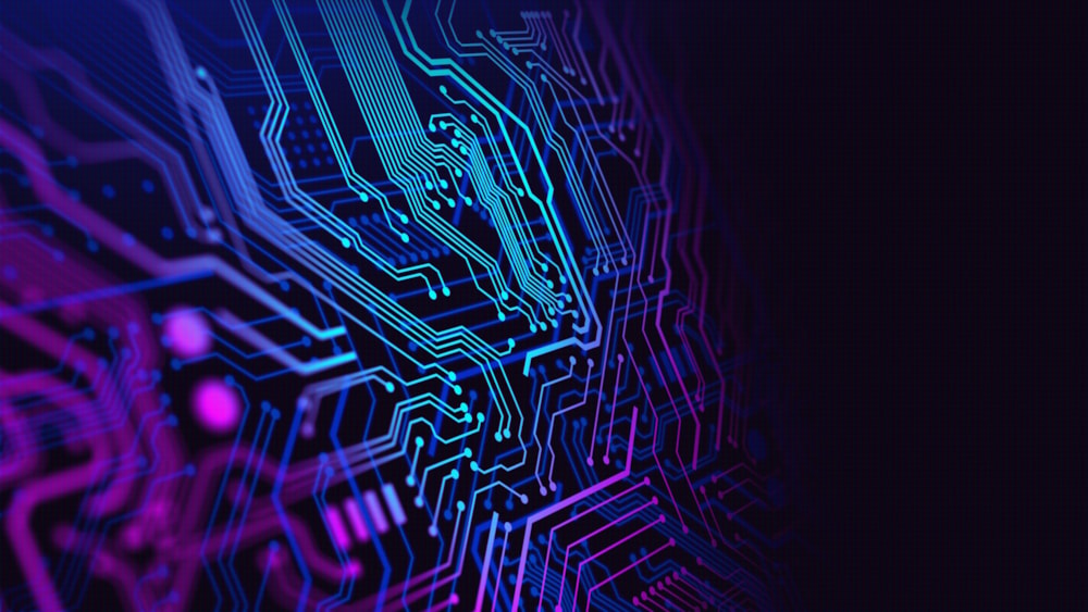 <p>Close-up of a blue and purple coloured circuit board.</p>