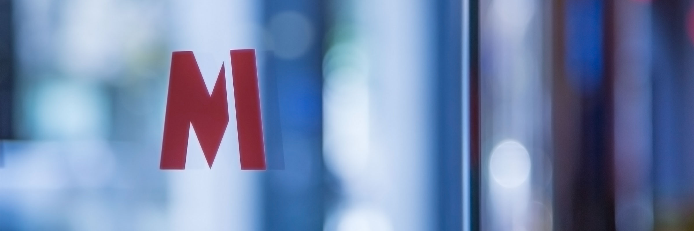 <p>Close-up of a Metro Bank M on window glass.</p>