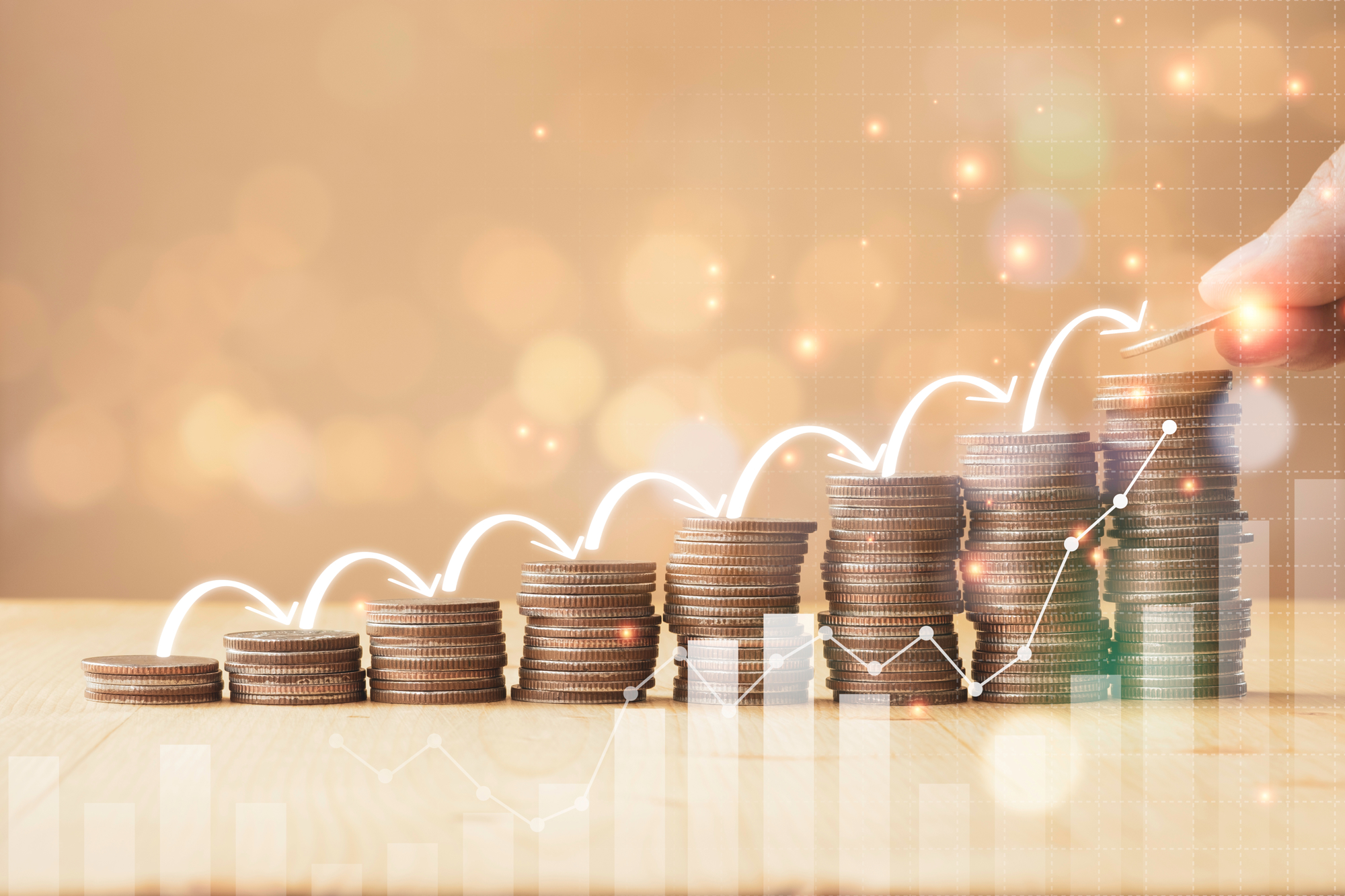 <p>Stacks of coins and an upward graph above.</p>