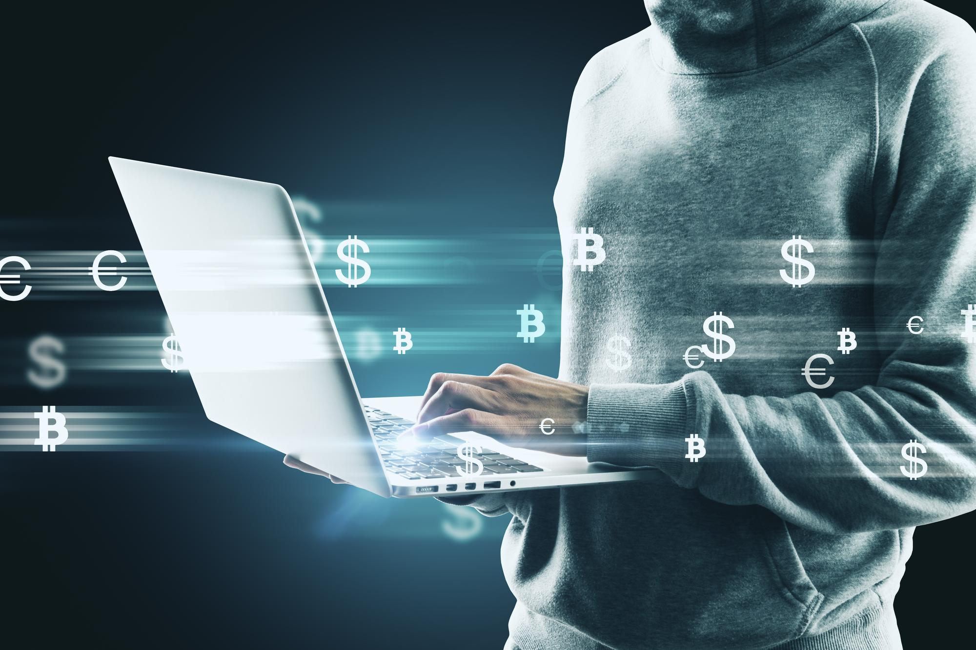 a man with a laptop working with currency