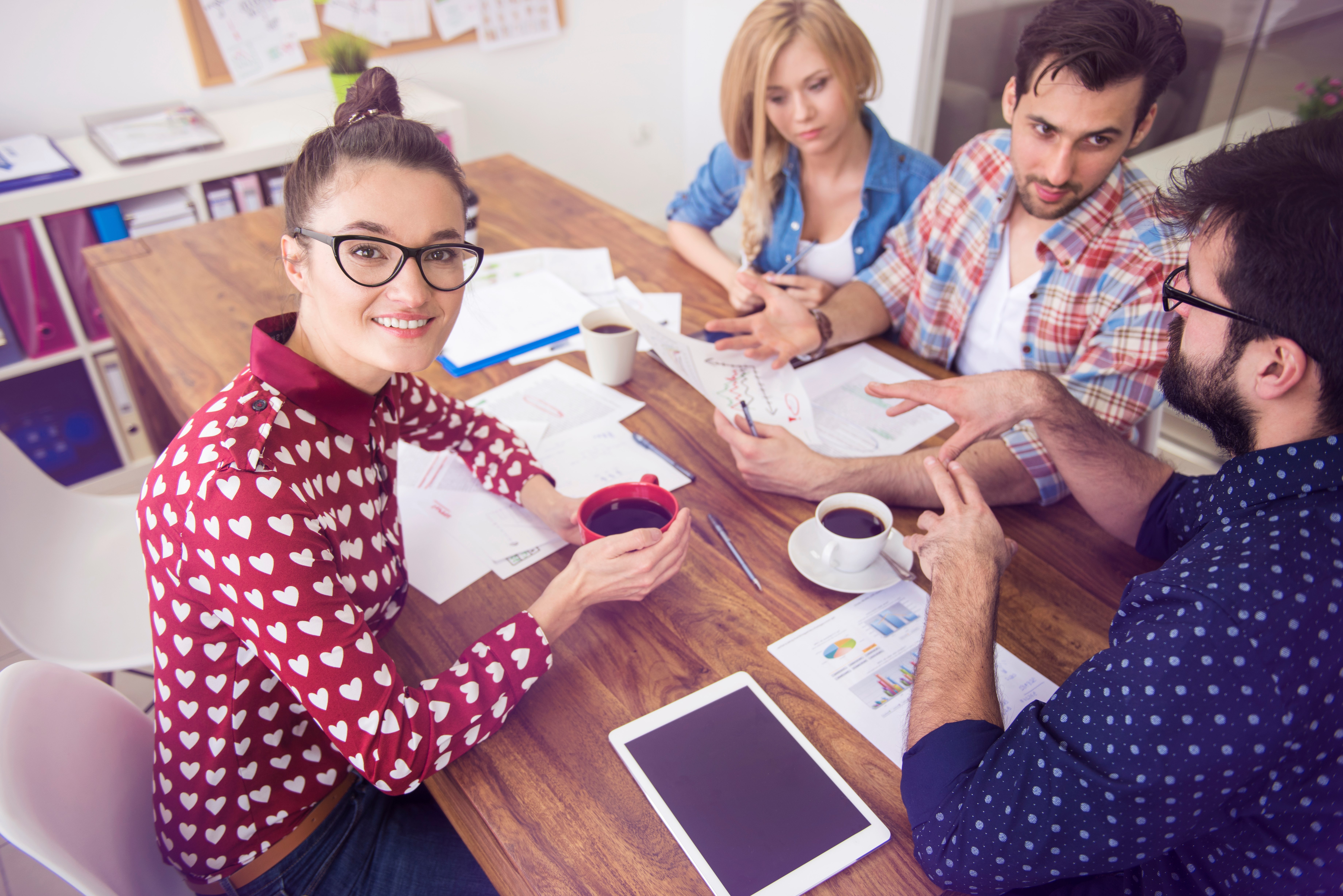 <p>A group of people discussing and working on a project.</p>