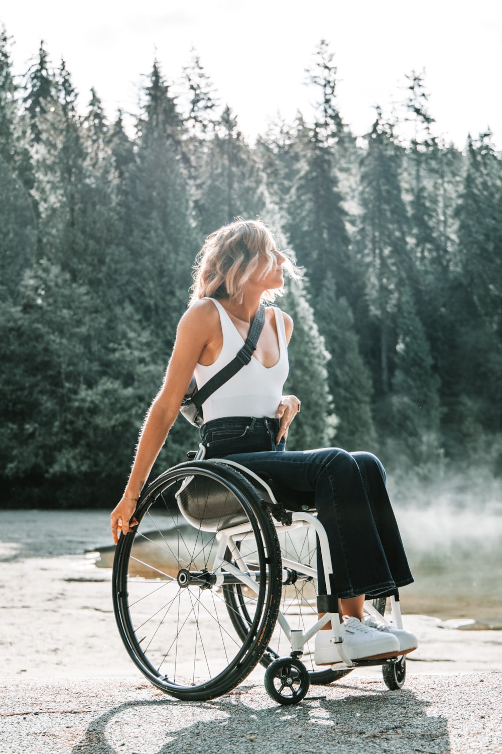 <p>Woman sitting in wheelchair outdoors in nature.</p>