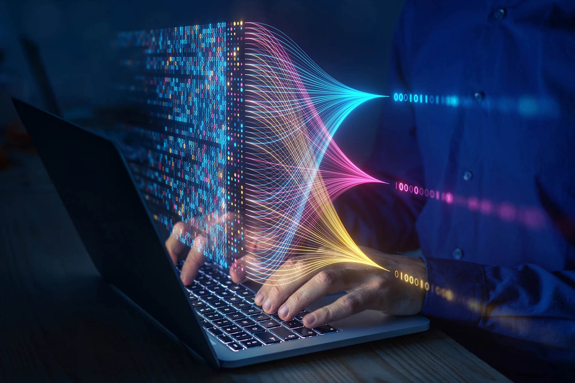 A person types on a laptop, with colorful data streams and binary code visualizing data flow above the keyboard.