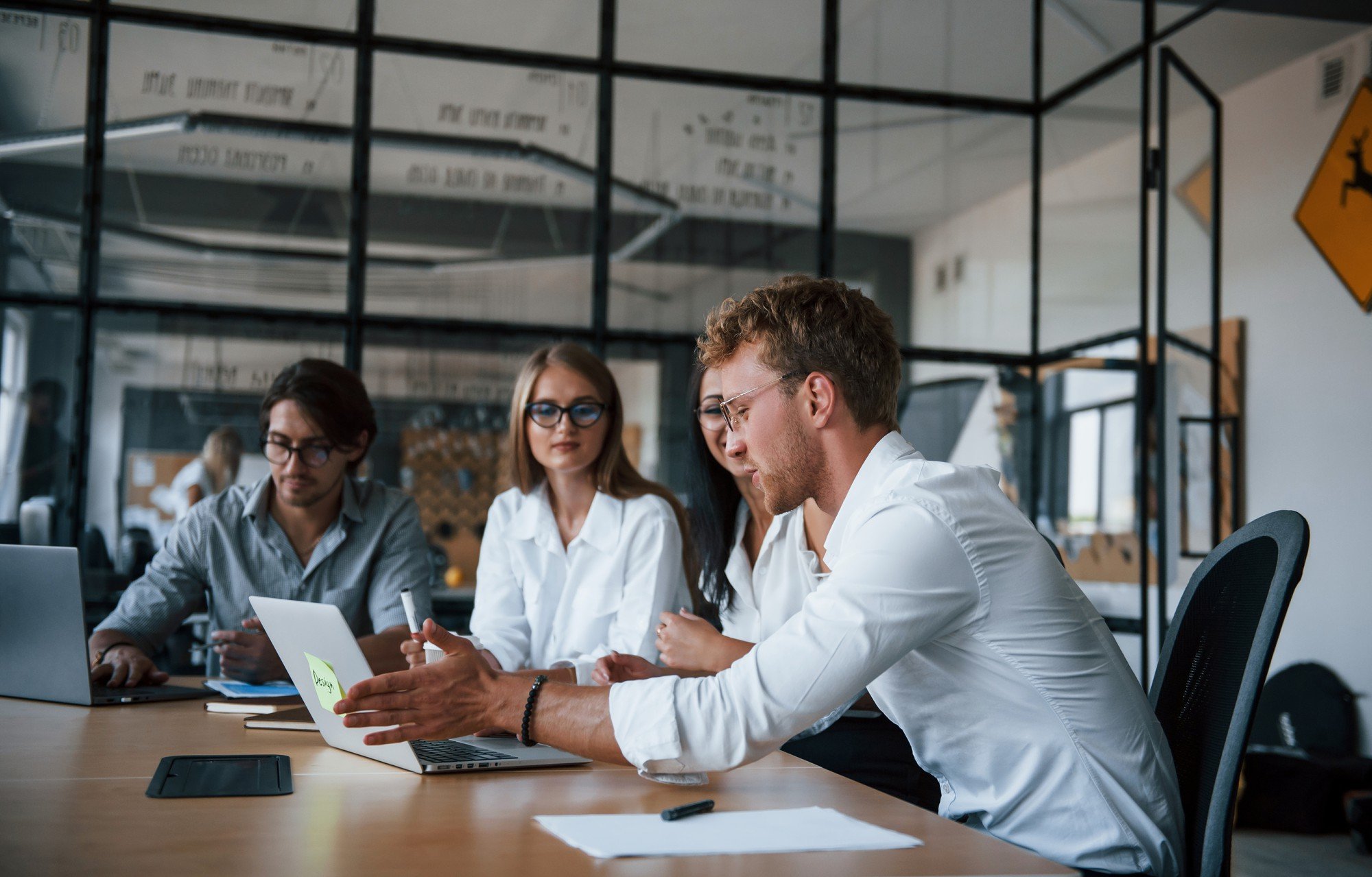 Group of young professionals collaborating around a table in a modern office.