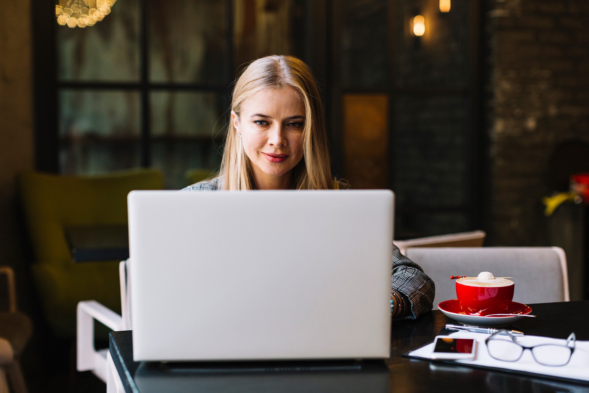 stylish-businesswoman-with-laptop-cosy-coffee-shop