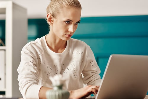 hard-working-woman-using-laptop-office
