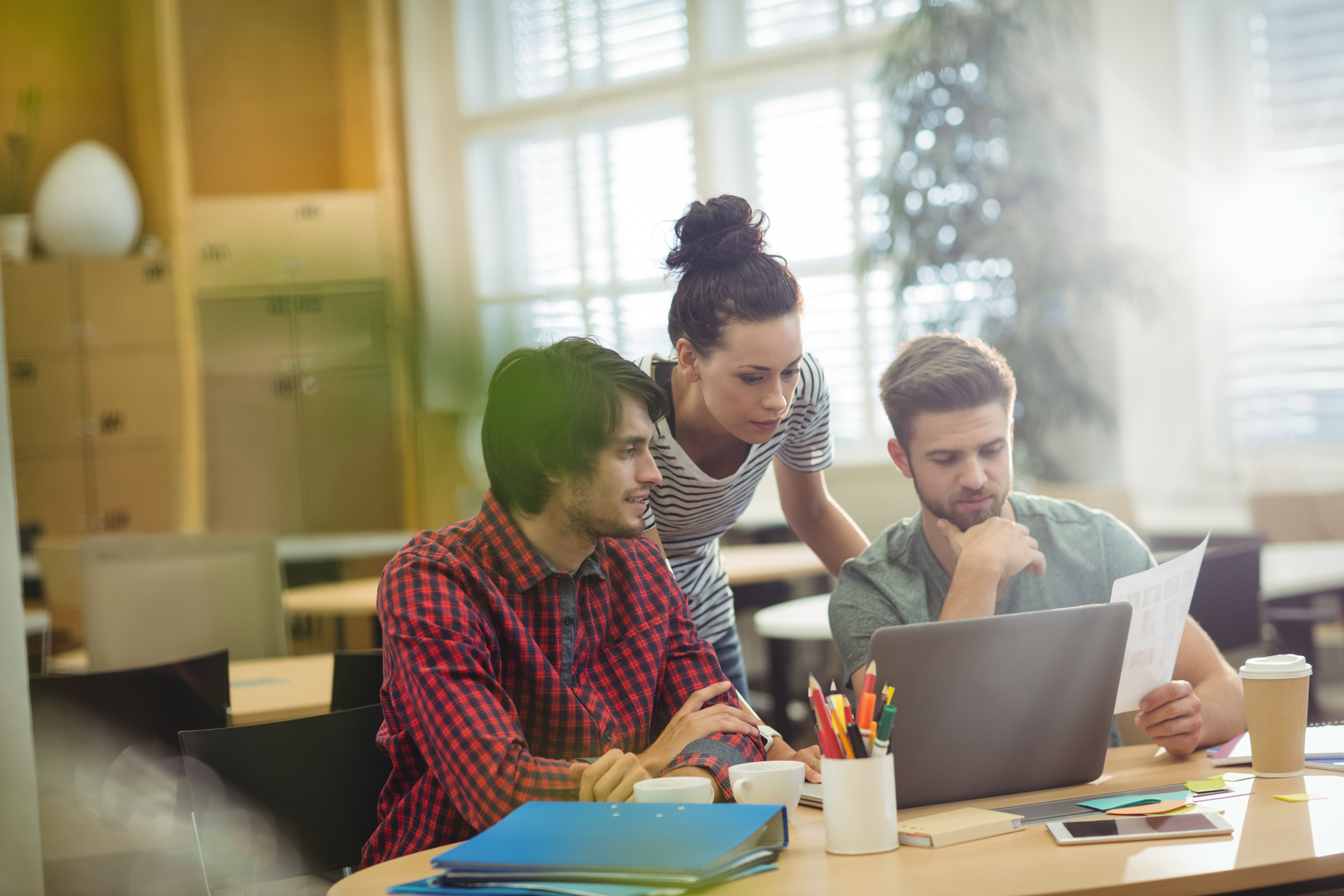 group-business-executives-discussing-laptop-their-des-2