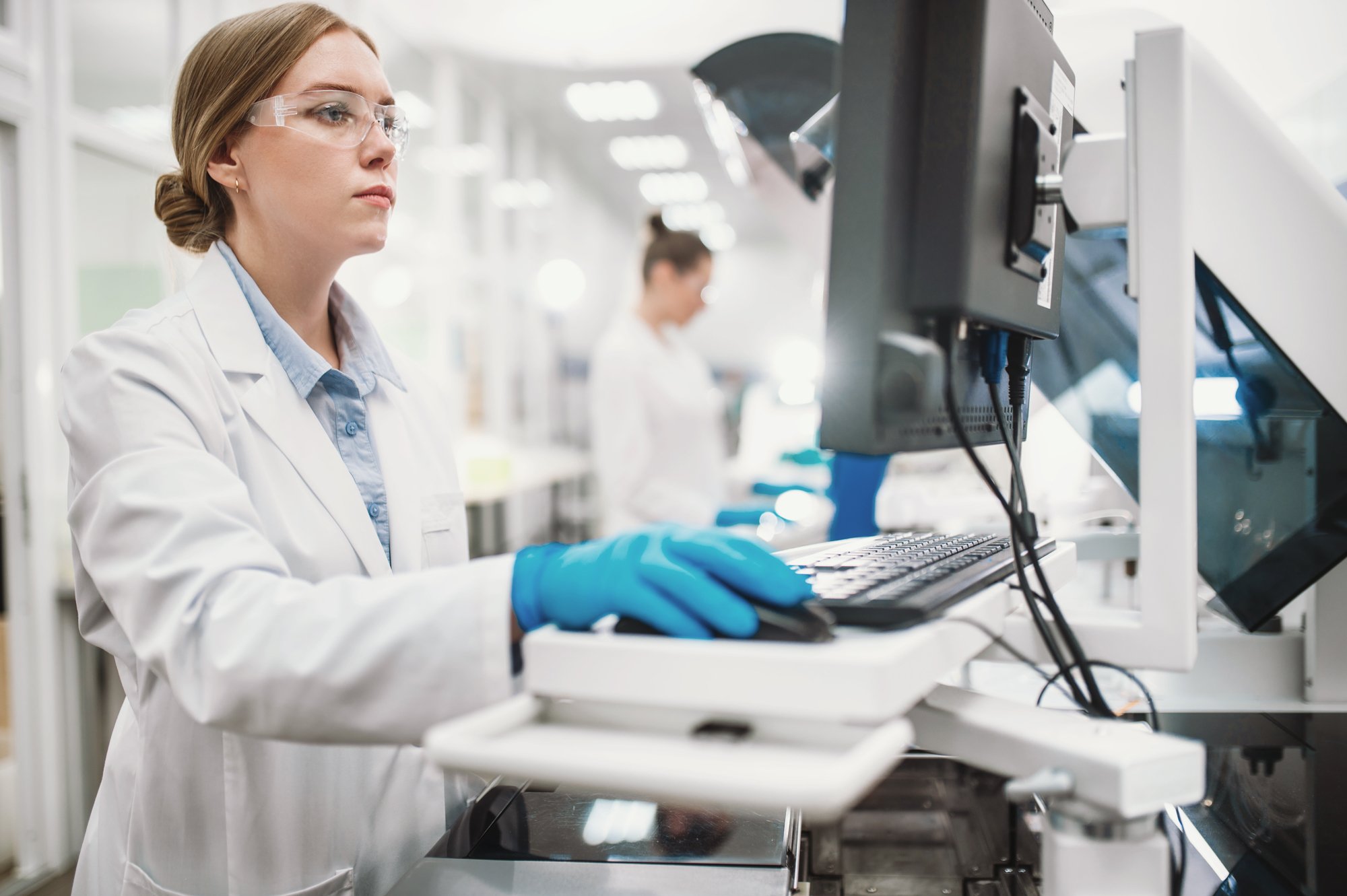 woman-scientist-in-laboratory-with-microscope